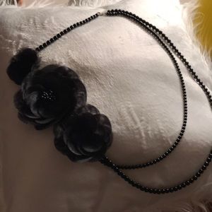Black beaded double strand necklace.